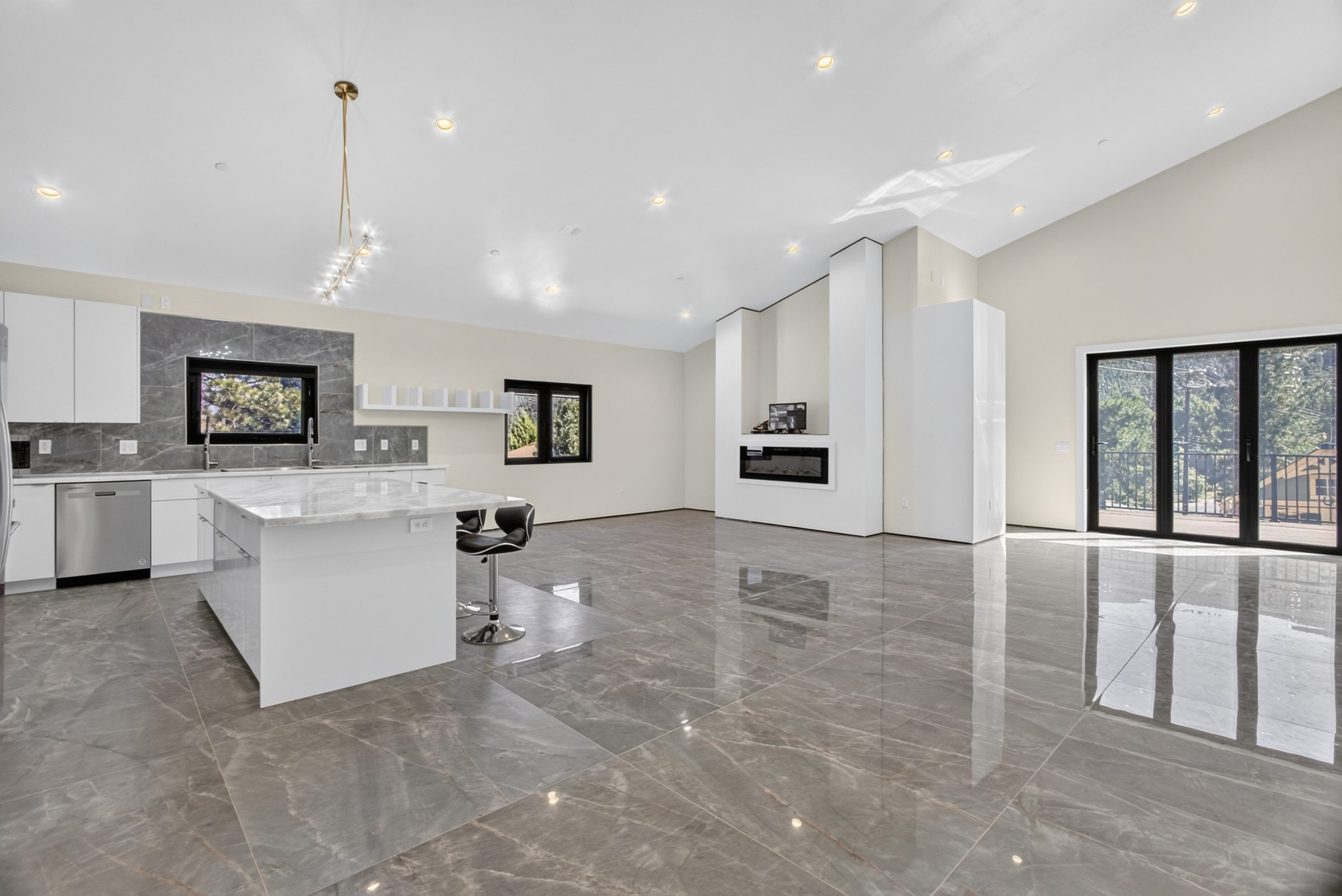Open kitchen and living space with polished tile floors